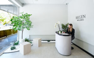 A woman in a modern and minimalist reception area at Regen Wellness